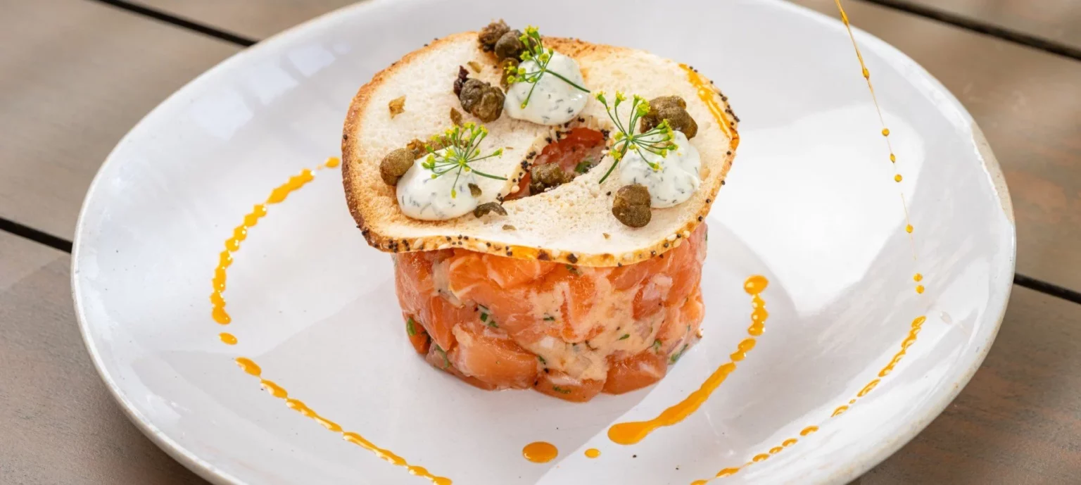 a plated fancy appetizer dish with garnished toppings.