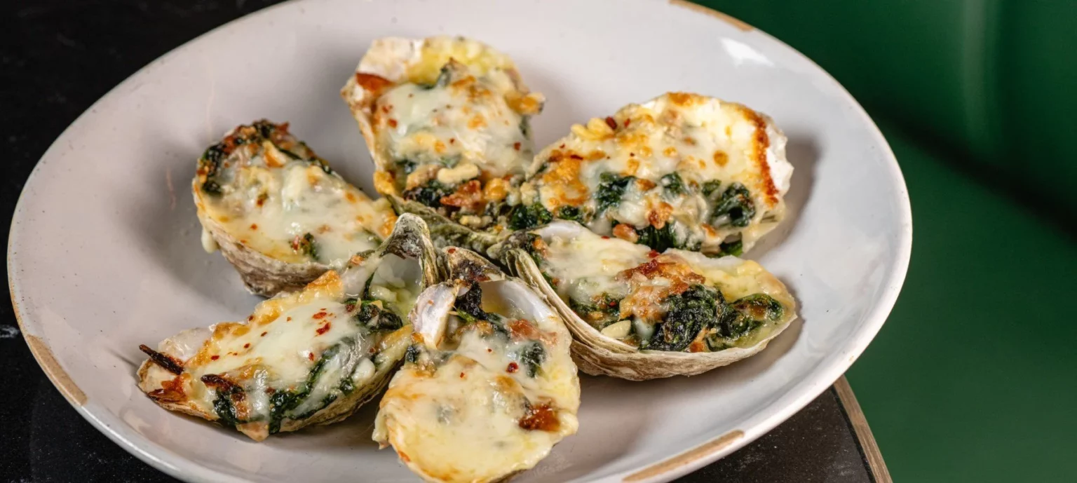 A plate of oysters stuffed with cheese and spinach.