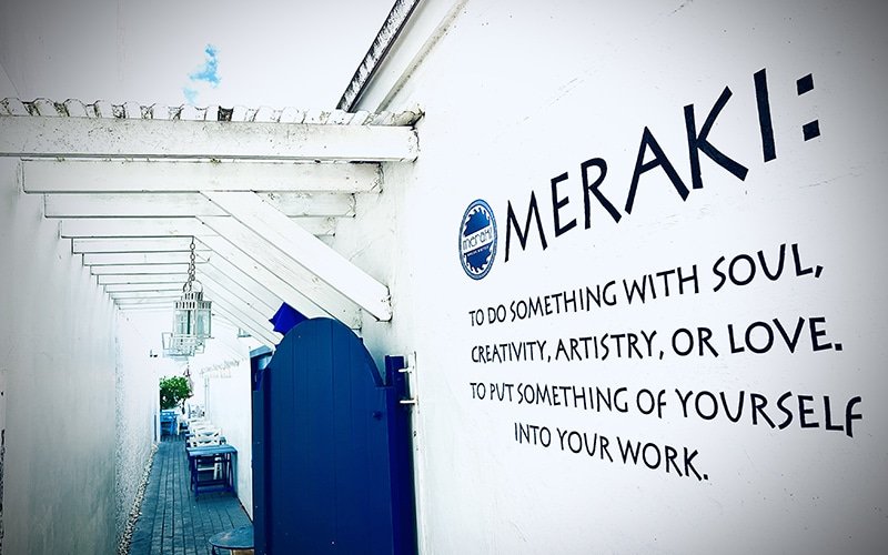 Outdoor sign of Meraki Greek Bistro, in Coconut Grove, FL.