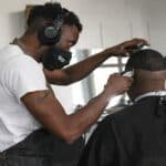 Barber cutting hair at Fade Masters Barbershop in Coconut Grove, FL.