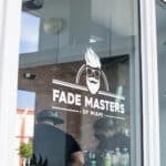 Fade Masters apron hanging from mirror in the barber shop, in Coconut Grove, FL.