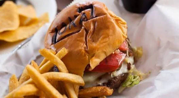 a burger next to fries.