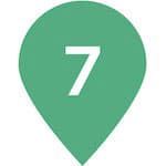 Light green map location icon with the number '7' in the middle. This illustrated icon provides indication of a location of a spot on a map.
