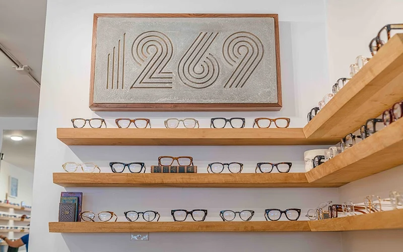 The 1269 inside sign above rows of glasses for purchase on the wall.
