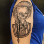 An image of a skeleton tattoo with long hair.