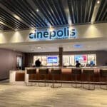 The Cinepolis interior movie theather with people working at the counter.