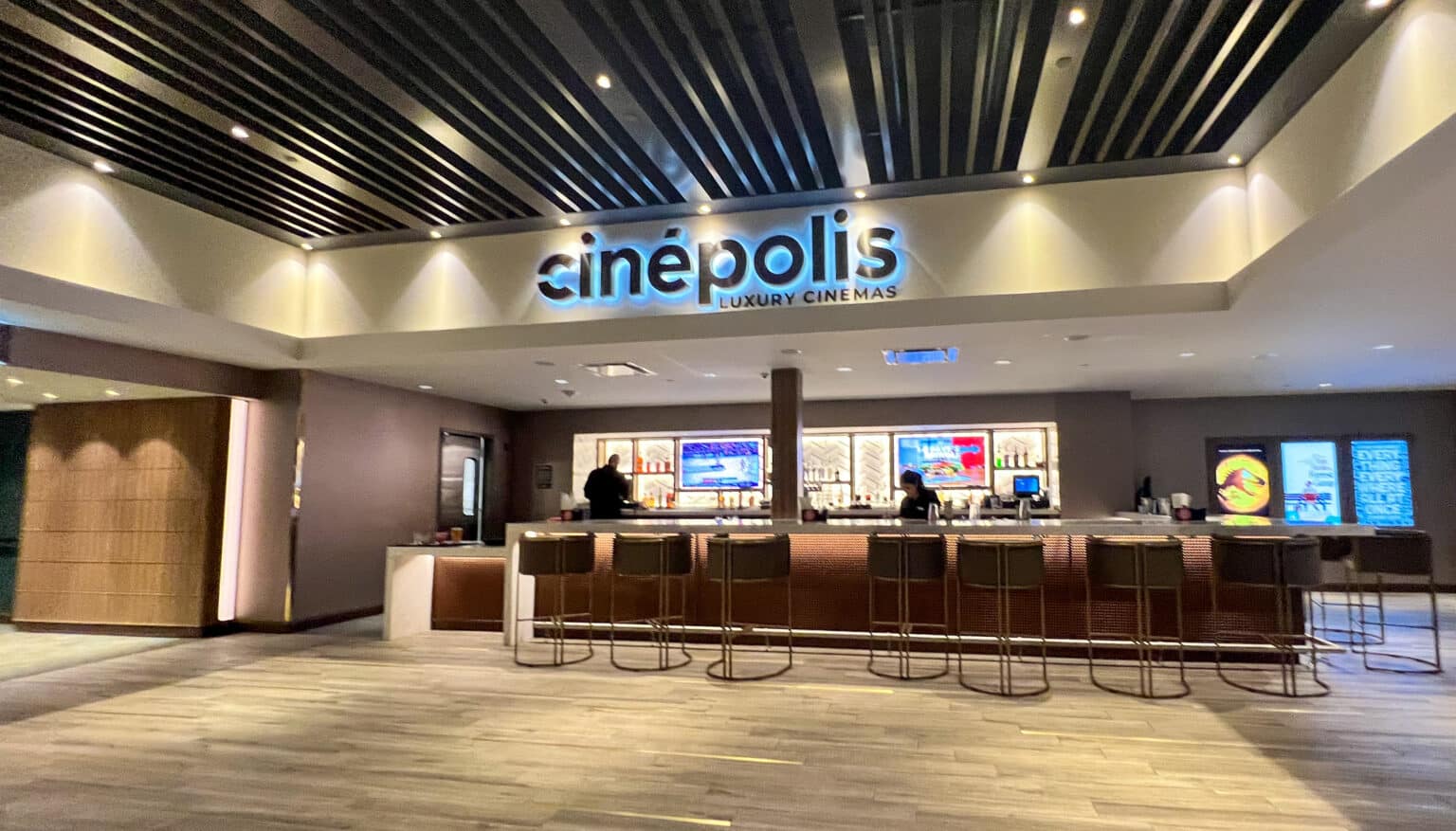 The Cinepolis interior movie theather with people working at the counter.