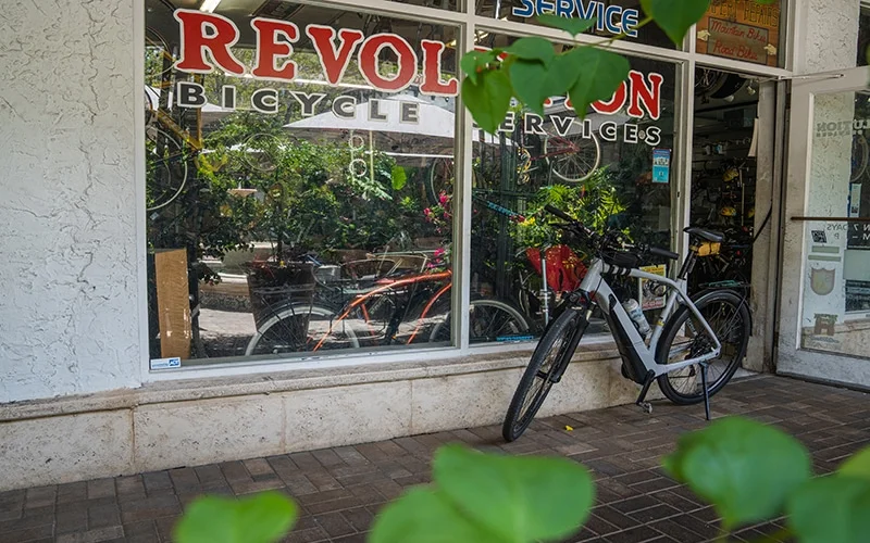 Revolution Bicycle Services with a bicycle in front of the buildilng.