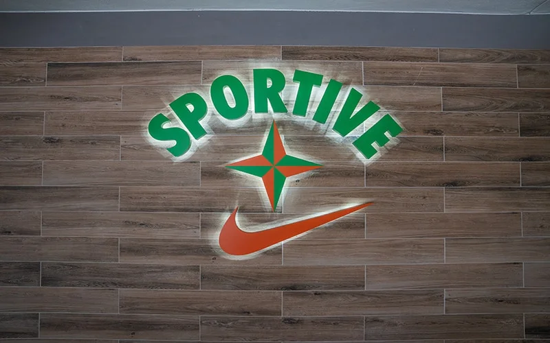 Sportive interior sign with lights hanging on the wall.