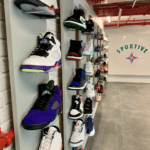 A display wall of shelves with shoes displayed on them.