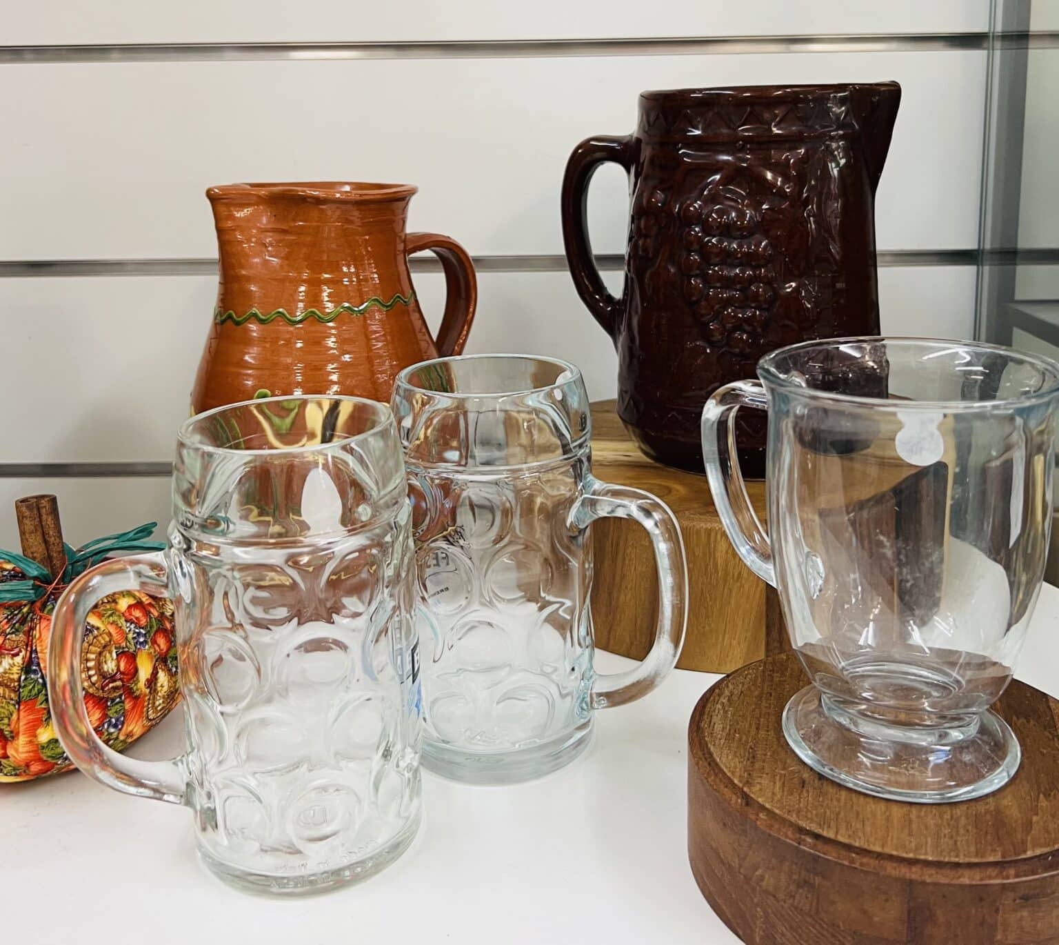 A table full of glasses and vintage amber pitchers