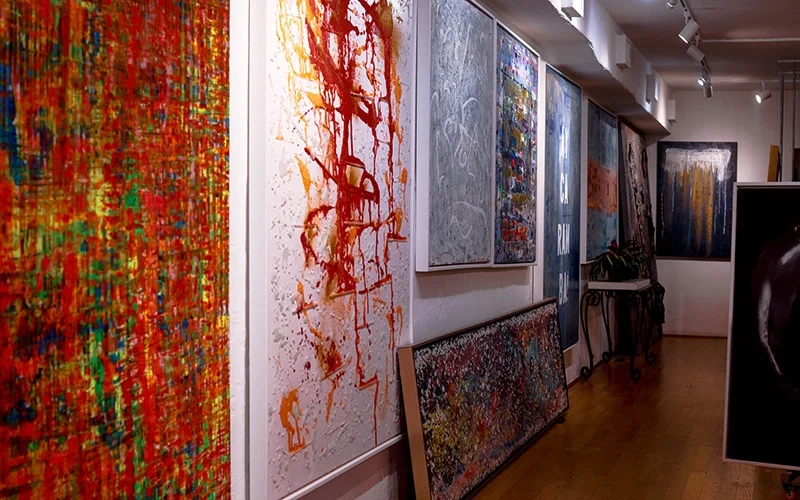 A bunch of paintings hanging inside of Grove Fine Art Center, Coconut Grove, FL.