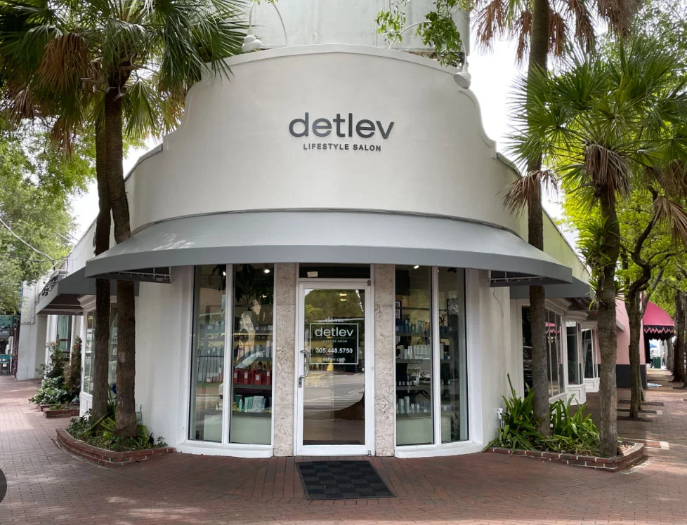 exterior view of Detlev shop with light gray rounded roof and glass front with white trim