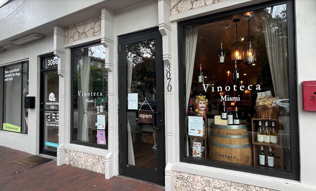 The exterior of the Vinoteca building with a wine display in the front window.