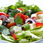 Greek salad with feta, tomatoes, black olives, cucumber and red onion.
