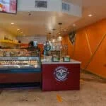 Inside of Morelia Gourmet Paletas in Coconut Grove, FL. A beautiful display of ice creams in a refrigerated food case.