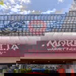 Morelia Gourmet Paletas exterior building red awning and greenery growing above the sign.
