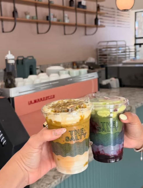 Banana Bread iced latte next to a Coconut Vanilla Cloud blueberry matcha latte.