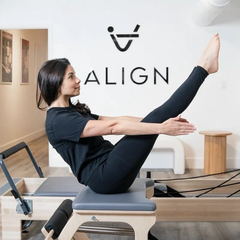 Lady performing a Pilates exercise at Align studios