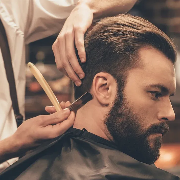Man getting his hair cut at a barber shop