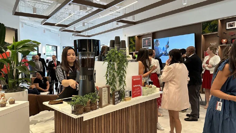 People mingling at a work cafe for coffee.