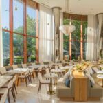 Bright, modern cafe seating area with large windows