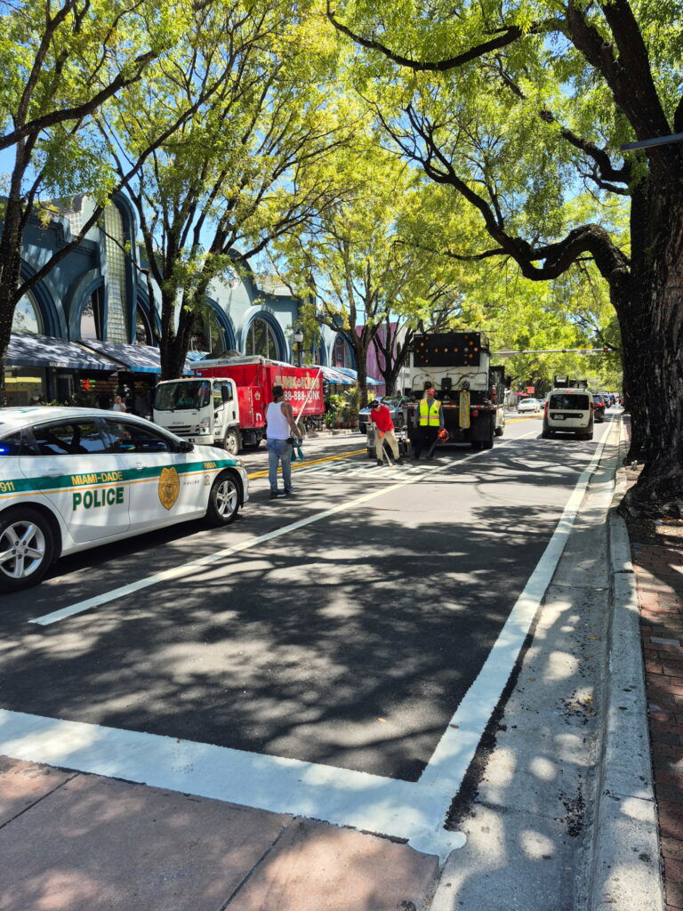 Workers working on a highway repaving blacktop repairs.