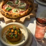 Neapolitan style Pizza, salad, and a cocktail.