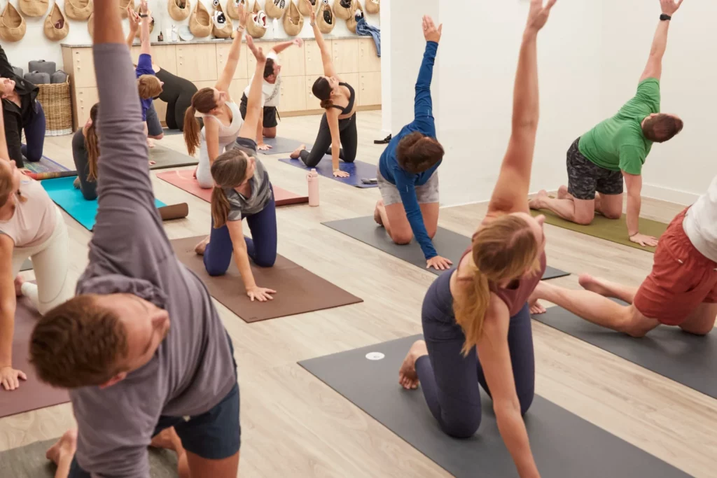 group of people doing Yoga in a studio
