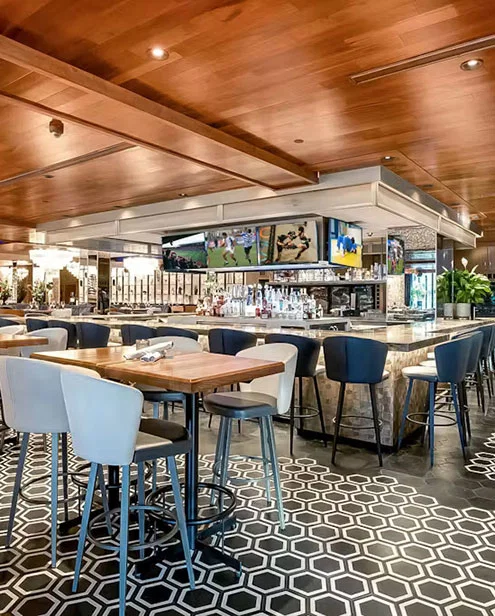chopsteakhouse interior with wood ceiling and tile floor