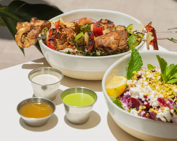 Grilled skewers with fresh salads and mixed vinaigrettes dressings.