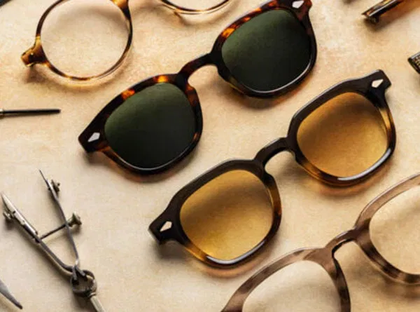 Variety of Sunglasses and glasses displayed close up.