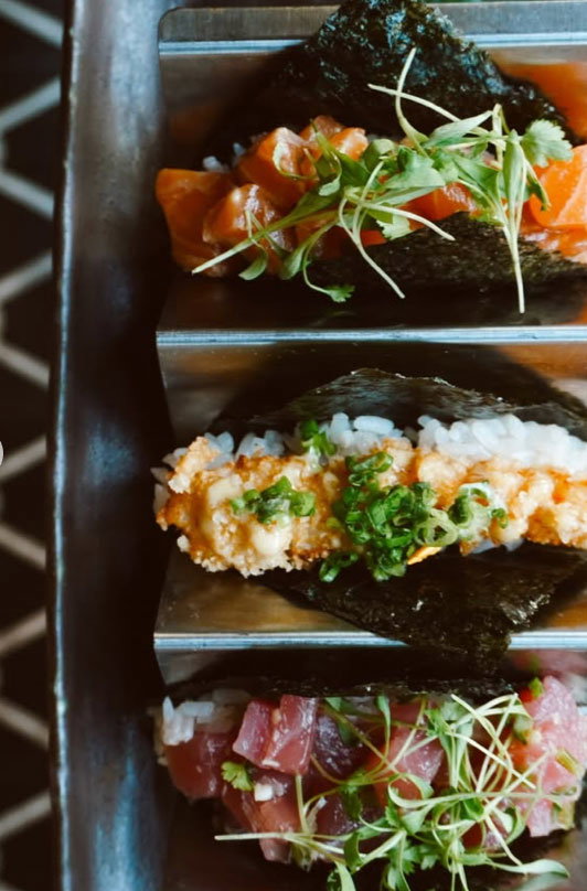three seaweed sushi tacos, topped with micro greens and chives.