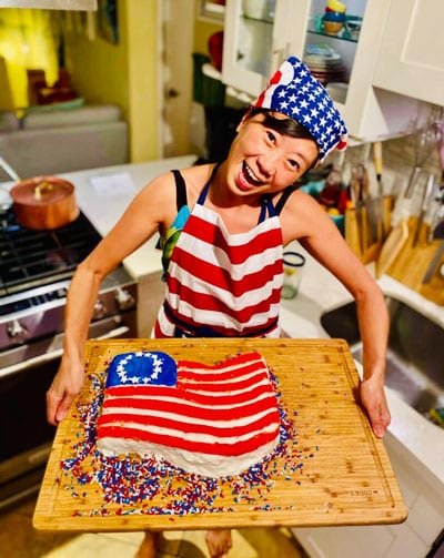 woman smiling american betsy ross flag cake